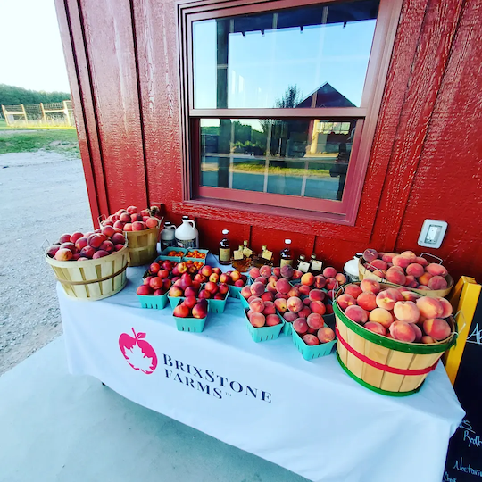 Brimstone Farm Market with apples, peaches next to red barn