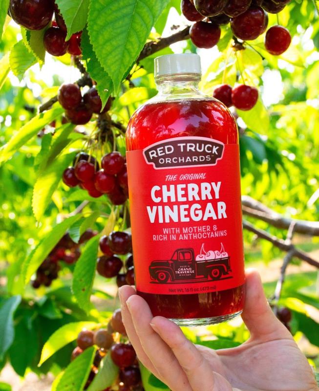 Hand holding a bottle of cherry vinegar at Haalstedt Homestead Cherries in Northport