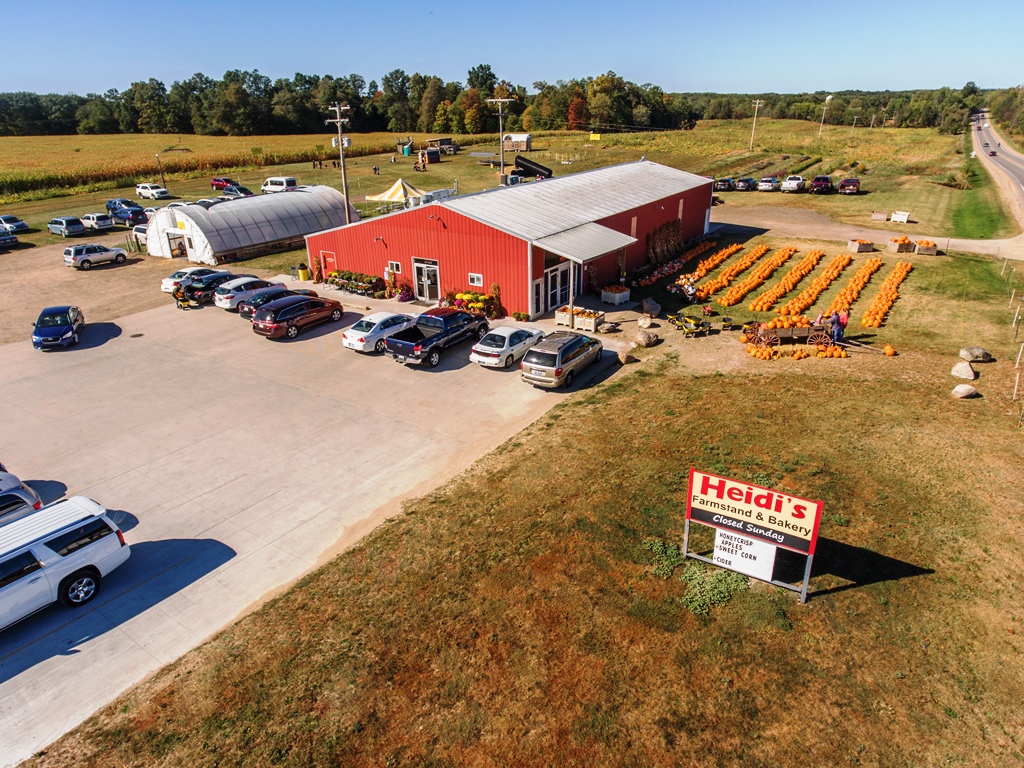 Farm market with fields of pumpkins, parking log