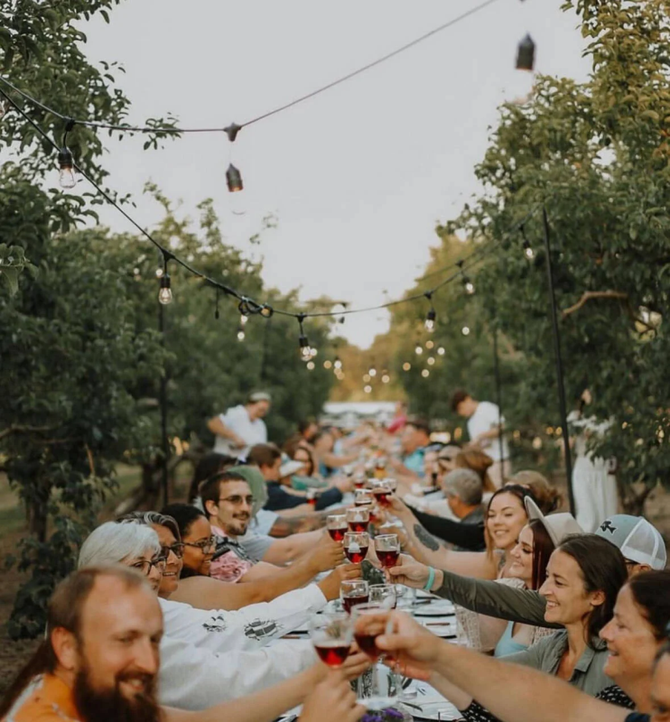 People having a dinner in the orchard at Sunshine Acres