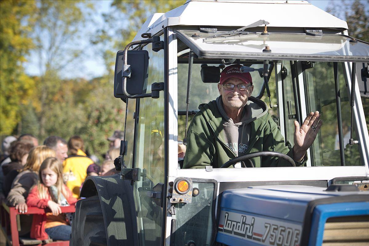 Farmer riding tractor at Kapnick Orchards in Britton