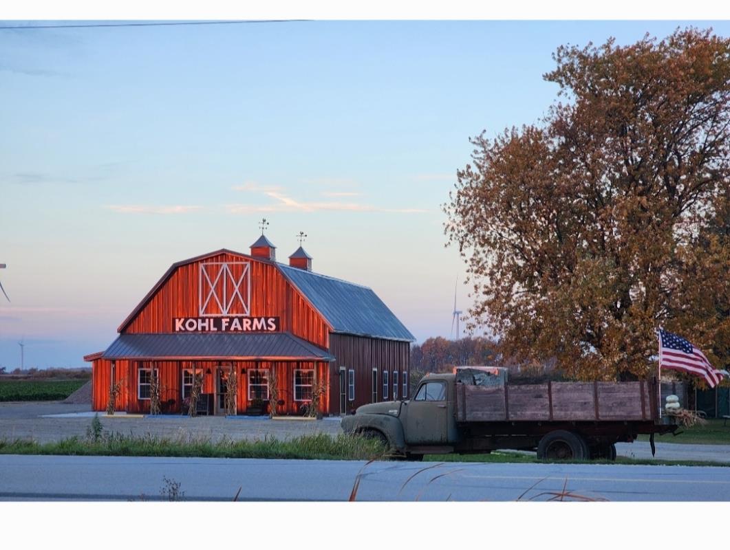 Red barn, blue sky, tree and truck at Kohl Farms in the Thumb