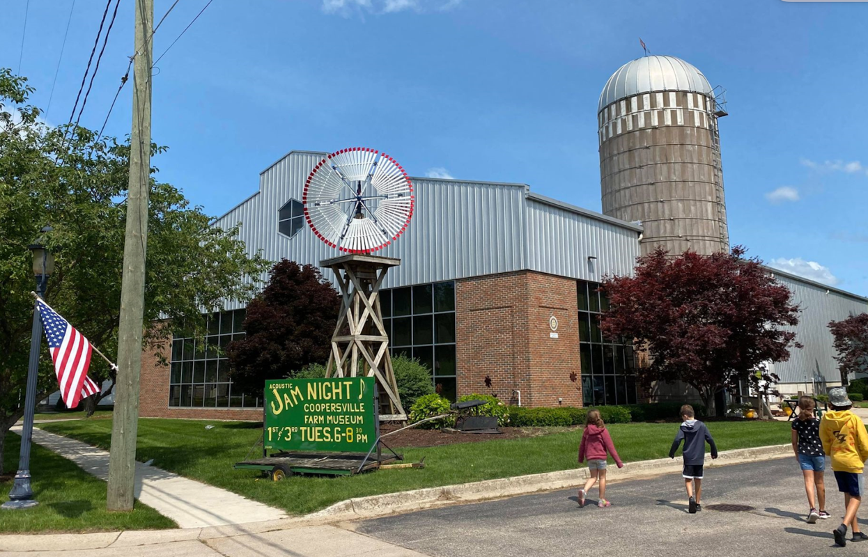 Cooperville Farm Museum with visitors outside, blue sky